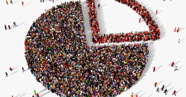 Large and diverse group of people seen from above gathered together in the shape of a pie chart