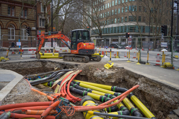 Roadworks,With,A,Digger,At,The,Side,Of,A,Large site.